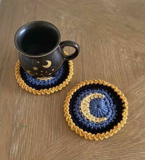 Moon and stars crochet coasters with a black mug